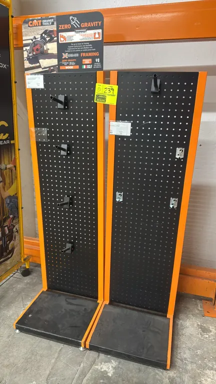 CMT Orange Tools metal pegboard display merchandisers. Lot includes (2) units featuring black perforated metal panels, orange frames, lower display sh