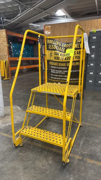 Cotterman 3-step rolling stock ladder. Features perforated steel slip-resistant treads, top platform, dual handrails, and spring-loaded casters. 450 l