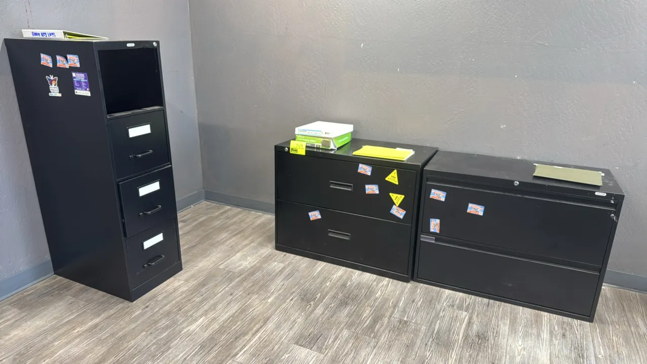Metal file cabinets. Includes (2) 2-drawer lateral file cabinets and (1) vertical file cabinet. Black metal construction. Features integrated and rece