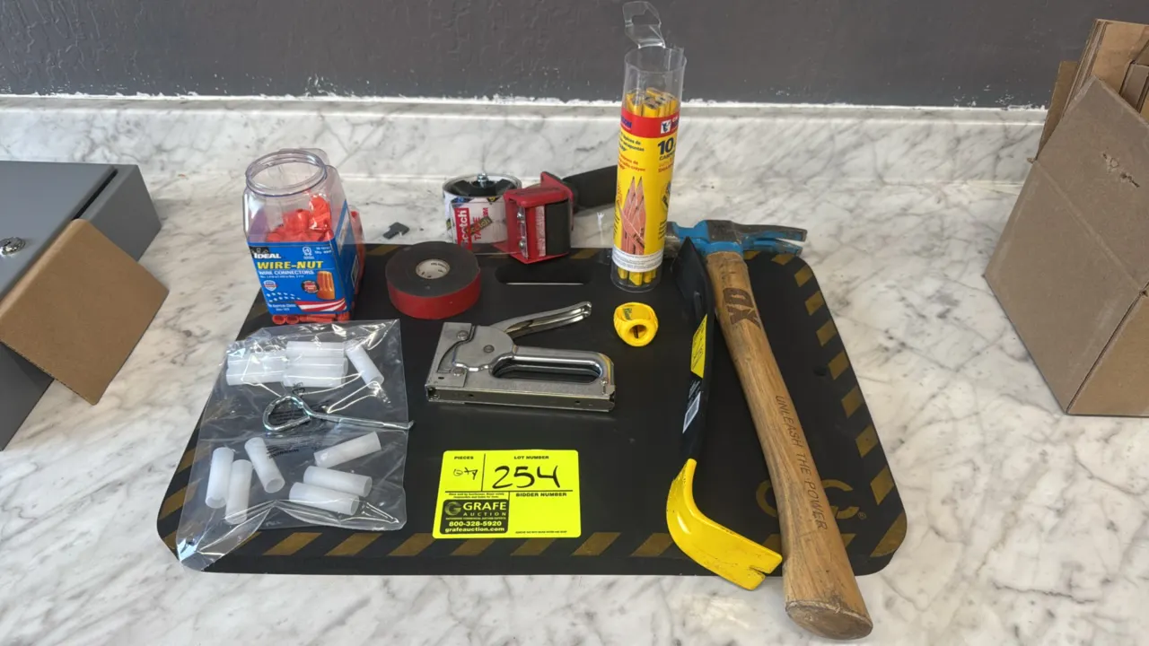 Assorted tools and supplies package lot. Includes foam kneeling pad, OX wood-handle hammer, Stanley pry bar, heavy-duty staple gun, packing tape dispe