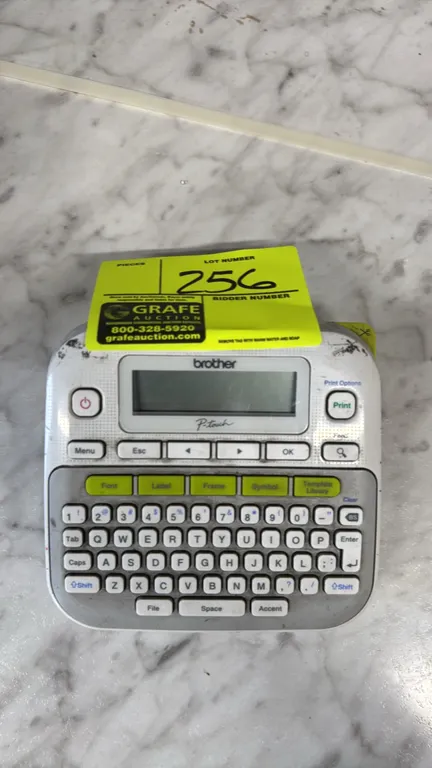 Brother P-touch PT-D210 label maker. Features QWERTY keyboard, graphical display, and one-touch formatting keys. Includes installed Brother TZe 12mm w
