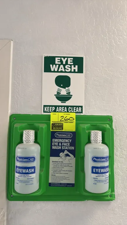 PhysiciansCARE emergency eye and face wash station. Includes (2) 32 fl. oz. sterile eyewash solution bottles and molded green wall-mount bracket. Feat