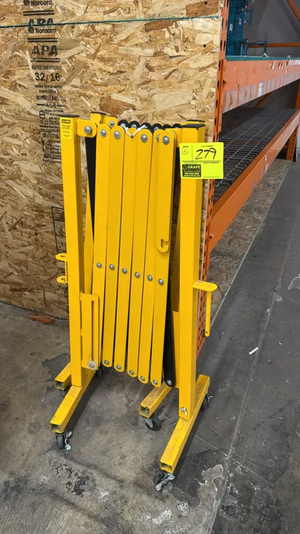 Uline H-2734 portable folding safety barriers. Features expandable scissor-gate steel construction and yellow finish. Mounted on casters. Note: One ca