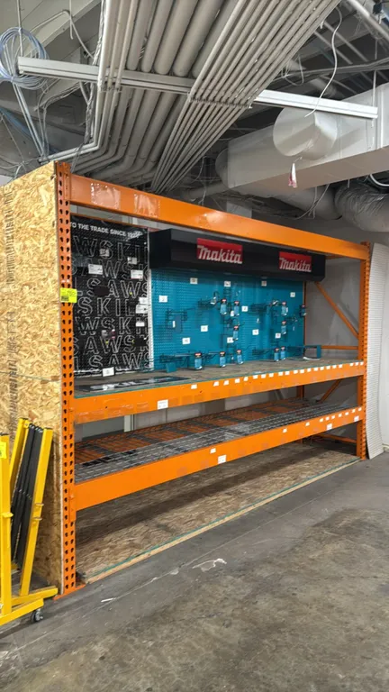12'L section of HMH pallet racking. Measures 34"D x 96"H. Features 6" crossbars, wood decking, and wire mesh decking. Includes Makita and Skilsaw pegb