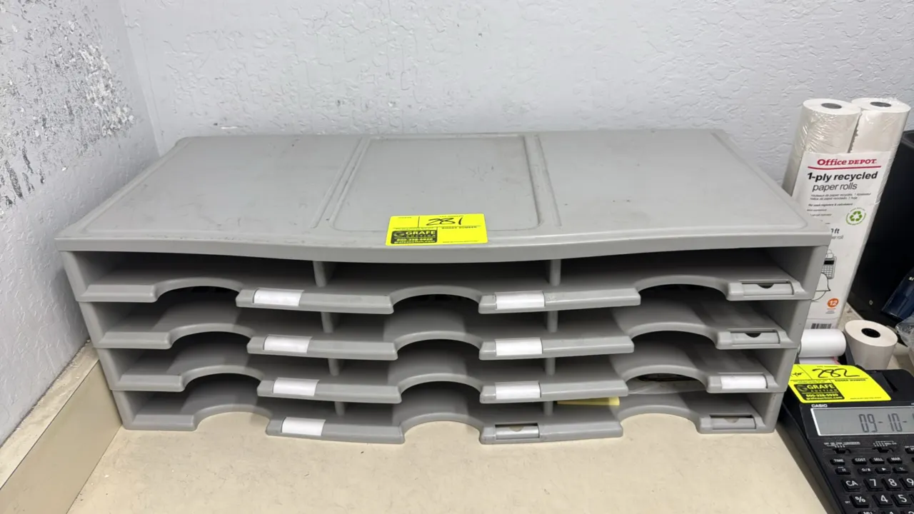 Poly mail sorter. Features gray molded plastic construction, 12 compartments across 4 tiers, and integrated shelf label holders. Dimensions: 32" x 13"