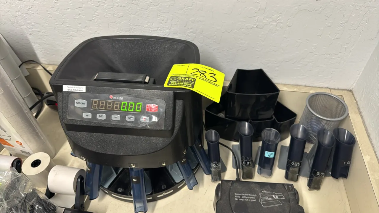 Cassida C200 electronic coin counter, sorter, and wrapper. Features top-loading hopper, digital LED display, batching and reporting functions, sorting
