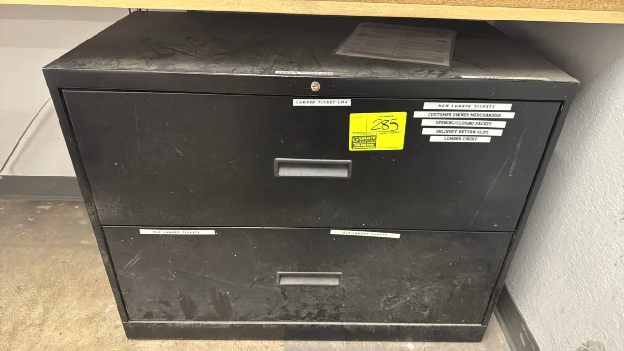 Metal 2-drawer lateral file cabinet. Features black finish, recessed pull handles, and top lock mechanism (key not included). 36"W. Contents not inclu