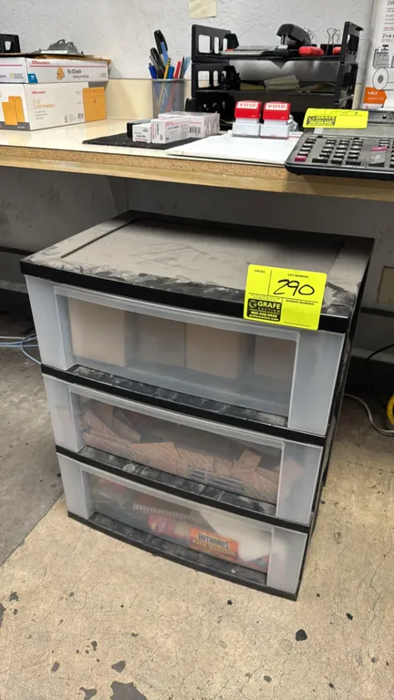 Poly 3-drawer storage organizer. Features a black plastic frame with three translucent sliding drawers. Includes contents containing assorted office s