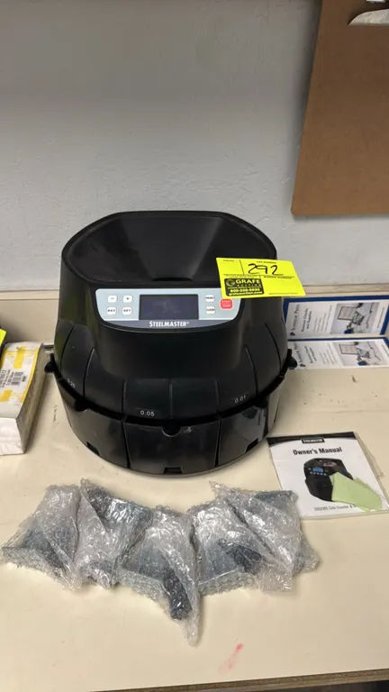 Steelmaster 200200C digital coin counter and sorter. Features top-loading hopper, digital display, denomination sorting bins, tube attachments, and ow