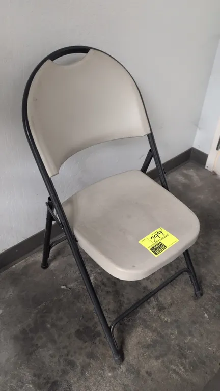 Poly folding chair. Features molded plastic contoured seat and backrest with integrated carry handle. Mounted on a tubular metal folding frame.