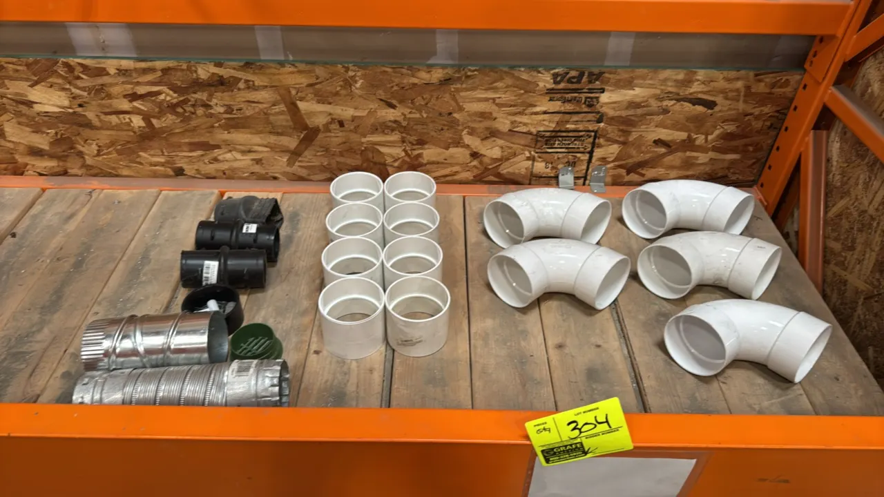 Assorted pipe and drainage fittings. Includes (5) PVC 90-degree elbows, (8) PVC couplings, ADS black plastic drainage fittings, galvanized metal duct