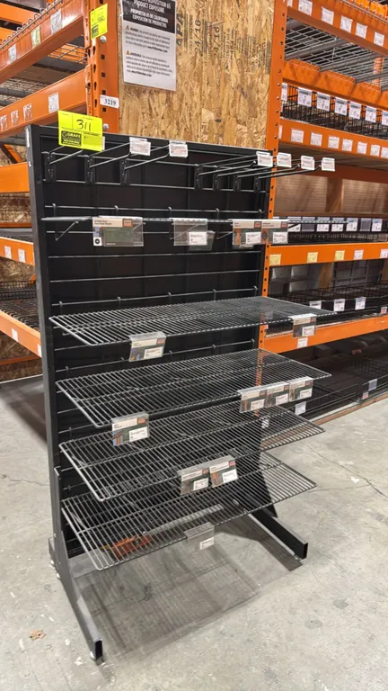 Metal multi-tier merchandiser display rack. Features (5) wire shelves, upper hanging display hooks, label holders, and a black finished metal frame. D
