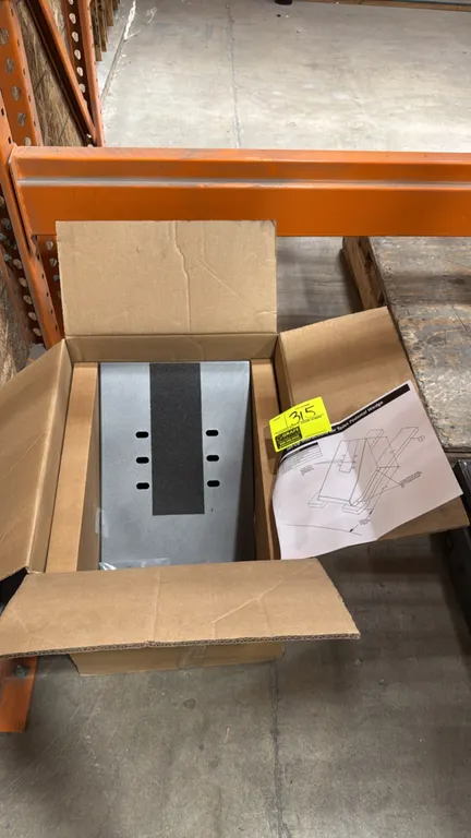 Toilet pedestal display wedge. Features steel construction with gray powder-coat finish, non-slip center strip, and pre-slotted mounting holes. Includ