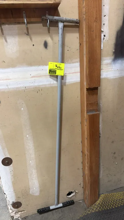 Metal push tool. Features welded tubular metal construction, a top T-handle, and molded grips on the lower crossbar. 5'L.