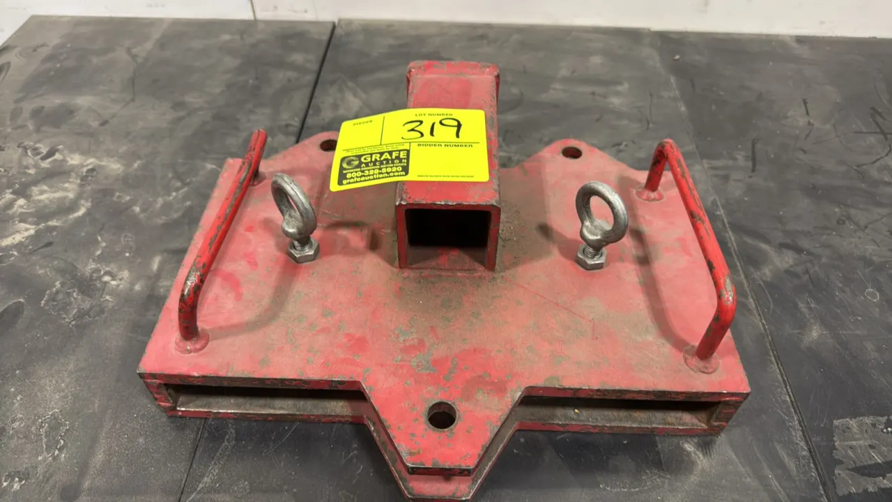 Forklift hitch attachment. Welded steel construction with red finish. Features integrated 2" receiver tube with pin hole, dual fork pockets, dual side