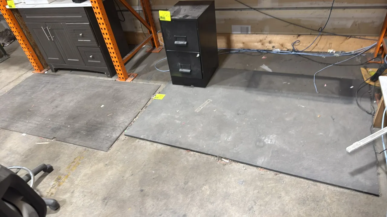 Anti-fatigue floor mats. Features ribbed surface texture and cushioned black construction. 6'L. File cabinet, vanity, and surrounding items not includ