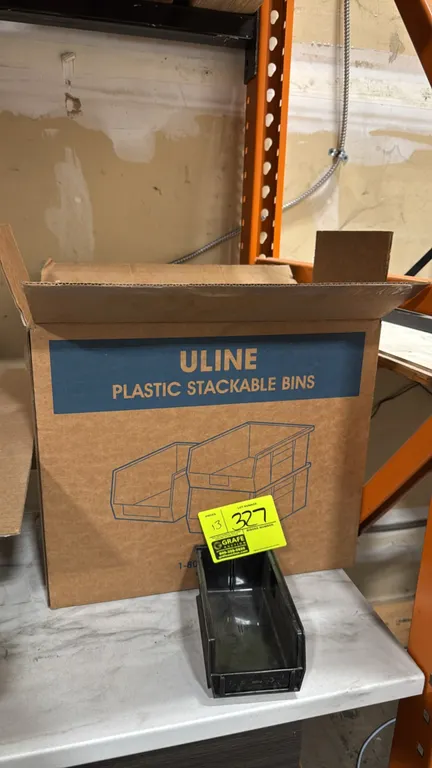 Uline S-12414BL plastic stackable bins. Features black polypropylene construction, open-hopper front design, and rear hanging lip. Dimensions: 7-1/2"