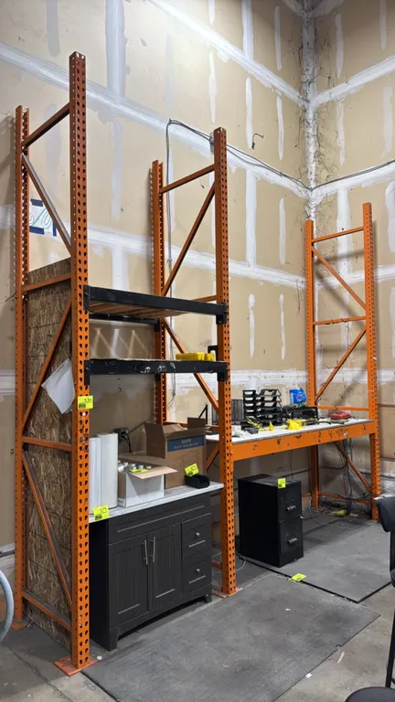 4'L and 8'L sections of HMH pallet racking. Features teardrop uprights, 5" and 3-1/2" cross beams, and wood decking. Upright dimensions: 34"D x 12'H.