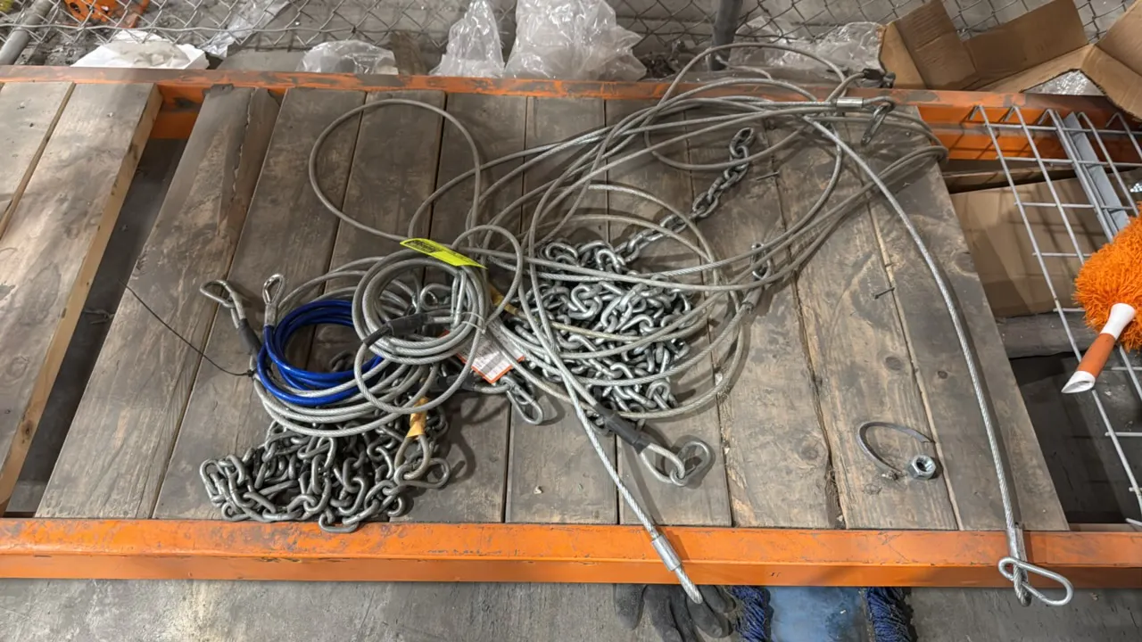 Package lot of assorted steel chain and wire rope cables. Features various lengths of galvanized and coated steel cables with looped ends, thimbles, a