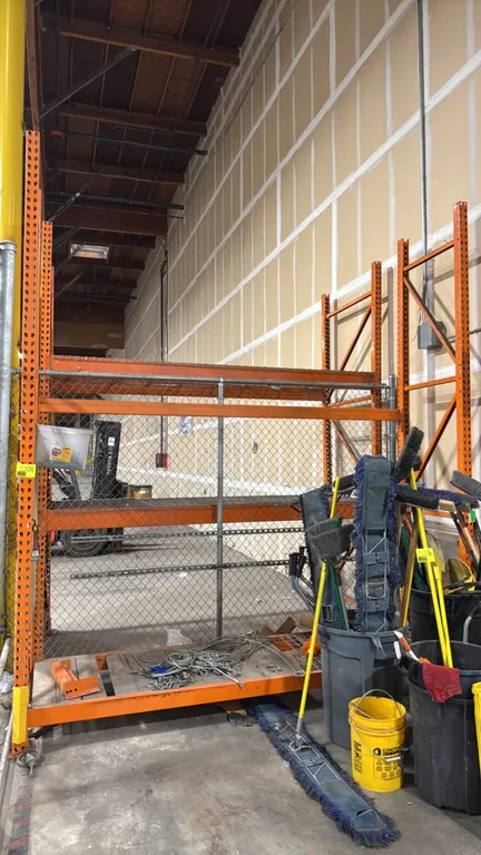 HMH pallet racking. Features 8' sections with 34" x 12'H uprights, 4" cross beams, wire mesh decking, and wood decking. Contents not included.