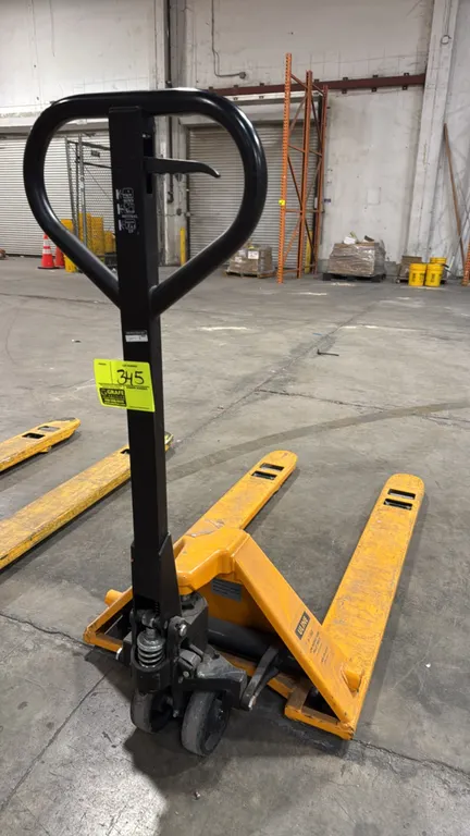 Uline H-1365 low profile pallet jack. Features a 3,300 lb load capacity, manual hydraulic pump operation, loop handle with 3-position hand release con