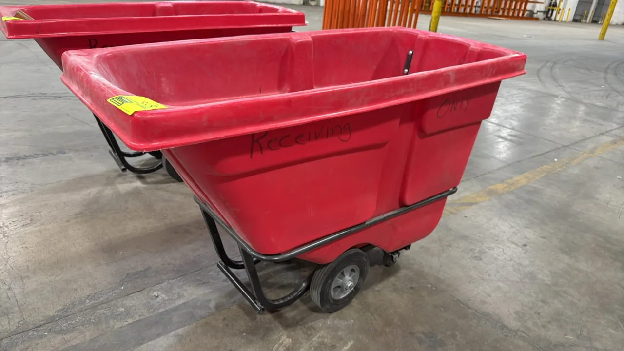 Uline 0.5 cu. yd. standard tilt truck. Features molded red polyethylene body, integrated push handle, and tubular steel frame. Mounted on wheels and s