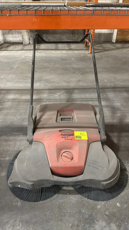 Haaga 497 iSweep walk-behind floor sweeper. Features dual rotating disc brushes, central height adjustment dial, removable rear debris collection hopp