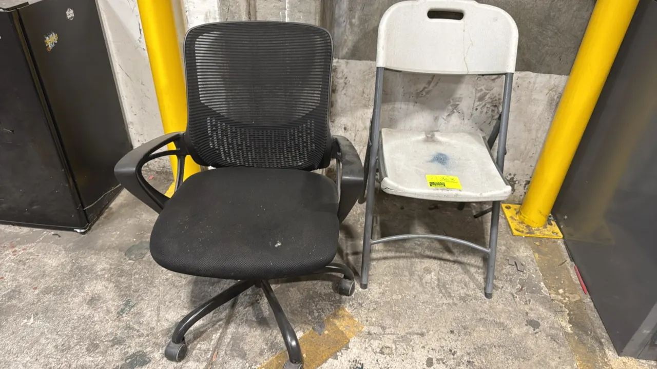 Assorted chairs. Includes (1) black mesh back office chair with fabric seat, fixed armrests, and 5-star caster base, and (1) molded plastic folding ch