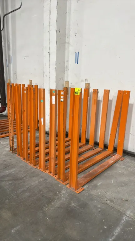 Metal storage stands. Welded steel U-frame construction with pre-drilled base plates for floor anchoring. Features pre-drilled mounting holes along up