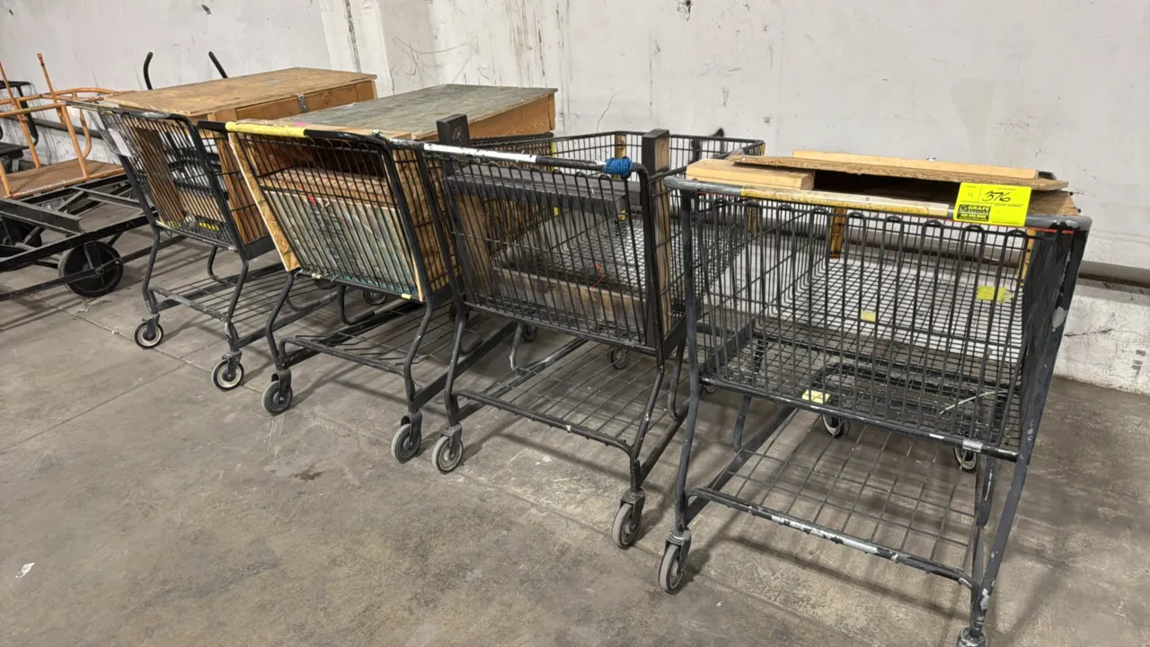 Custom configured shopping carts. Features wire metal baskets fitted with custom plywood and OSB wood tops and inserts, lower wire storage shelves, an