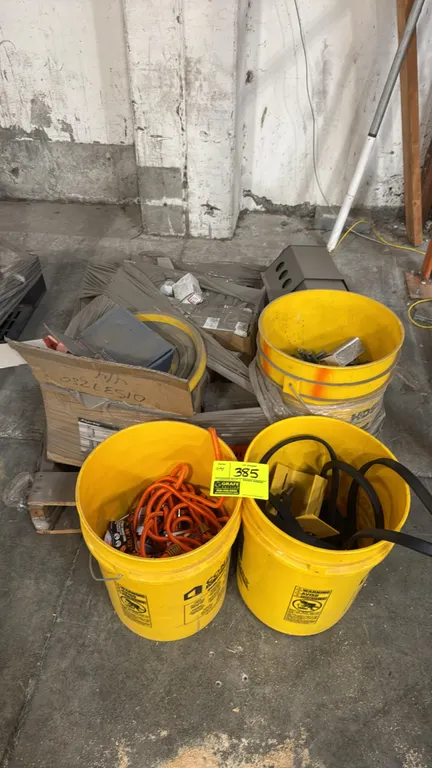 Hardware package lot. Includes yellow plastic buckets containing assorted bolts, concrete anchor fasteners, bungee cords, straps, metal brackets, and