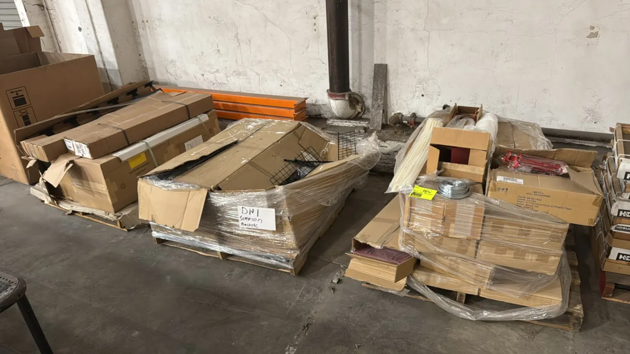 Package lot of assorted retail merchandising display components across 3 pallets. Includes 6" red peg hooks with label holders, cable ties, coiled wir