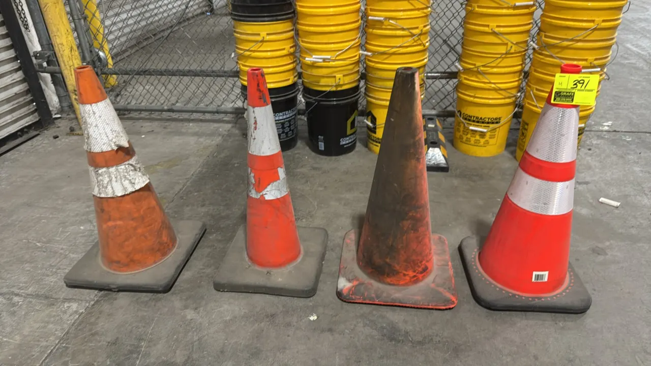 Orange vinyl traffic safety cones. Features weighted square bases and reflective collar striping on select units.