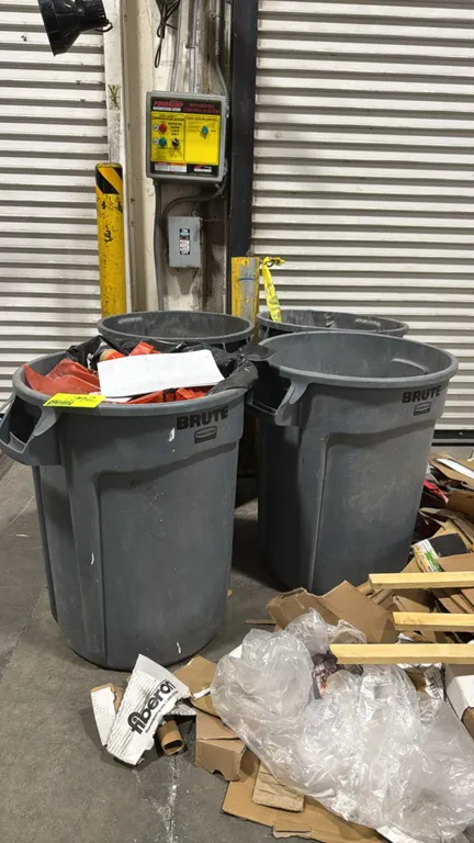 Rubbermaid Brute polyethylene trash cans. Features gray molded plastic construction with integrated side handles. Contents not included.