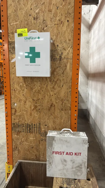 Metal first aid cabinets. Includes (1) UniFirst First Aid Station stocked with assorted first aid supplies and (1) empty cabinet. Features steel const
