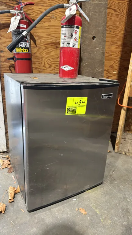 Magic Chef compact refrigerator. Features stainless steel finish door, black cabinet, mechanical temperature control, two interior wire shelves, and i