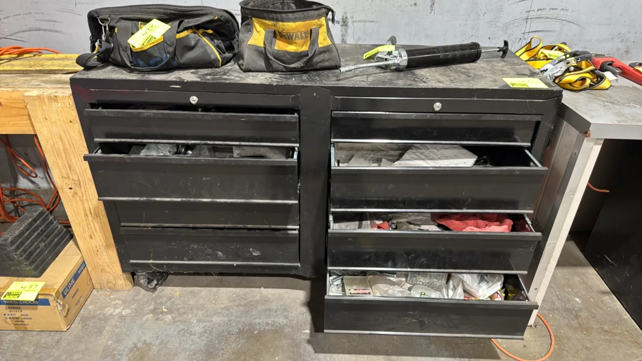 Metal portable 8-drawer tool chest. Features a dual-bank configuration and includes various hand tools, hardware, and fasteners within the drawers. 53