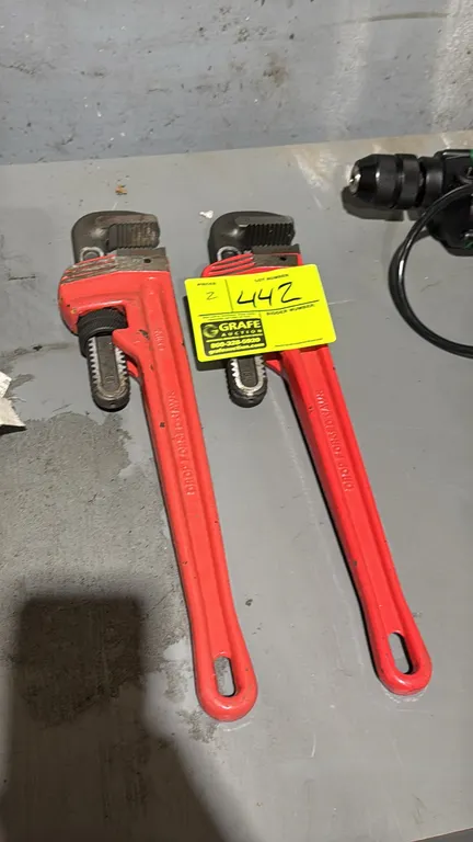 KC Pro 18" pipe wrenches. Features drop-forged steel jaws, knurled adjustment nuts, and red handles with hang holes.