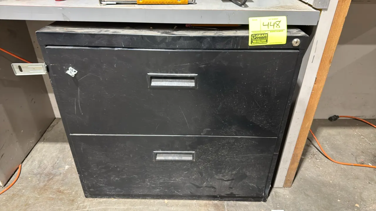 Metal 2-drawer lateral file cabinet. Features a black finish, recessed drawer pulls, upper lock cylinder, and an attached side padlock hasp. 30"W. Key