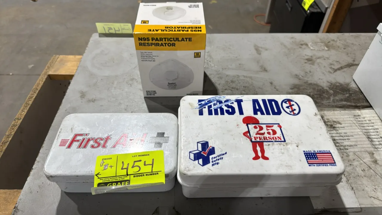 Assorted first aid kits with N95 masks. Includes two portable first aid kit boxes containing bandages, gauze pads, cold pack, gloves, and antiseptic w