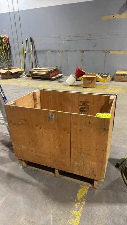 Plywood storage crate. Features hinged top lid, front metal hasp latch, and integrated pallet skid base. 36" x 21" x 30". Contents not included.