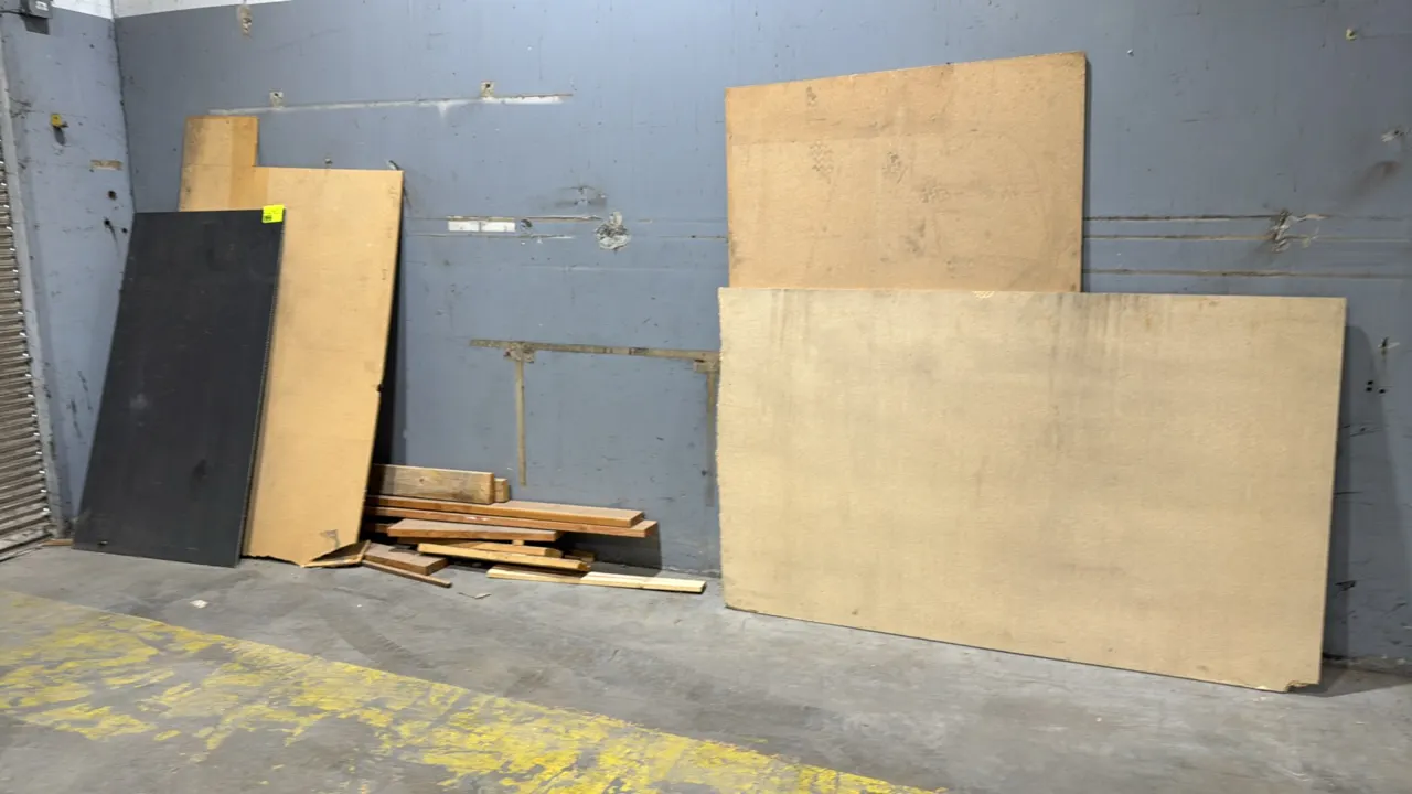 Bulk lot of assorted scrap wood and lumber. Includes various dimensional lumber planks and composite wood panels in assorted sizes.