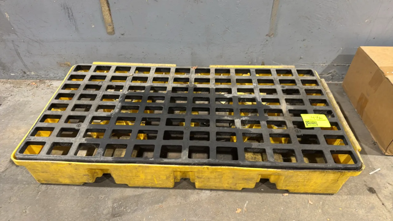 Eagle polyethylene spill containment drain tub. Features yellow polyethylene basin and removable black grating. Dimensions: 52"L x 26"W.