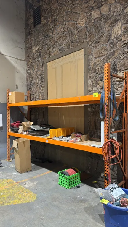 12'L Interlake pallet racking section. Features 34" x 8'H uprights, 4" cross beams, and wood decking. Includes various contents as pictured.