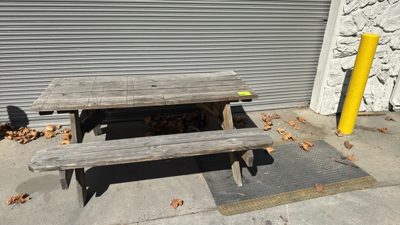 Wood picnic table with attached benches and anti-fatigue mat. Features solid wood construction with center umbrella hole. Includes a diamond-plate pat