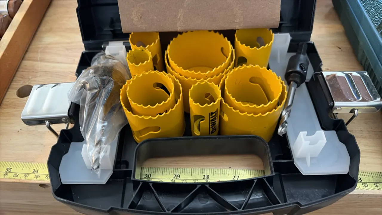 DeWalt hole saw kit. Includes assorted hole saw cups and arbors with pilot drill bits. Housed in a molded plastic carry case with metal latches.