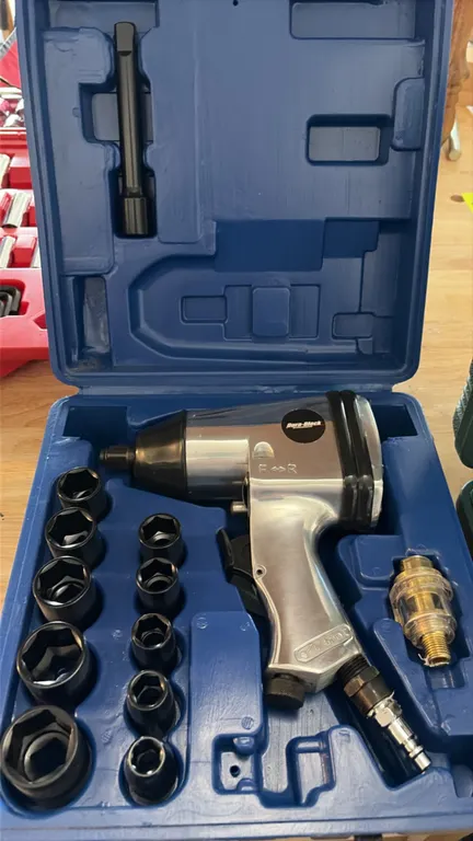 Pneumatic tool set. Includes Dura-Block pneumatic impact wrench kit with (10) impact sockets, extension bar, mini in-line oiler, and blow-molded case.
