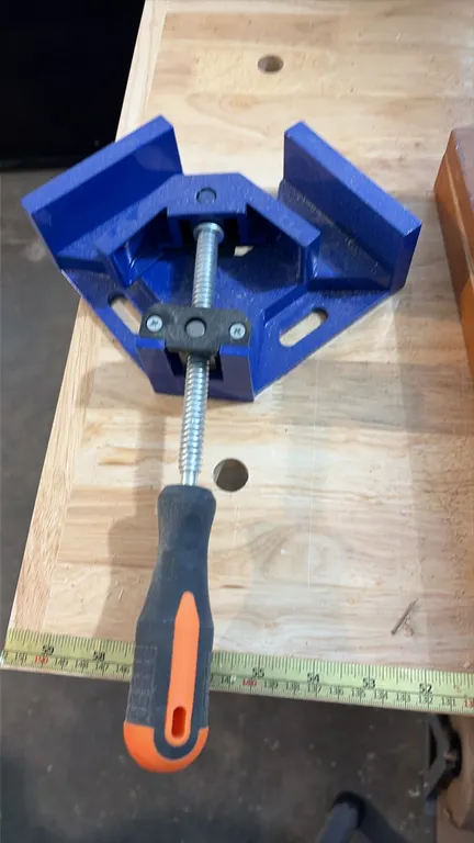 Right angle corner clamps. Features 90-degree clamping angle with adjustable swing jaw, threaded steel spindle, ergonomic rubberized grip handle, and