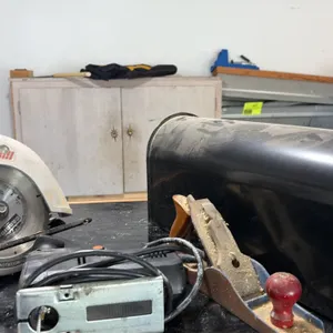 Tool, mailbox, and side table lot. Includes black metal mailbox, Craftsman Sawmill 7-1/4" circular saw (2-1/4 HP, 12A), Black & Decker electric jigsaw