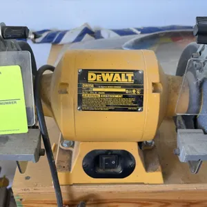 DeWalt DW756 6" bench grinder. Features dual 6" grinding wheels, clear eye shields, adjustable tool rests, and 1/2" arbor. 3,450 RPM. Electrical: 120V
